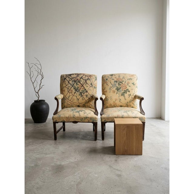 The image shows an antique open armchair that resembles a George II or George III period Gainsborough or library armchair...