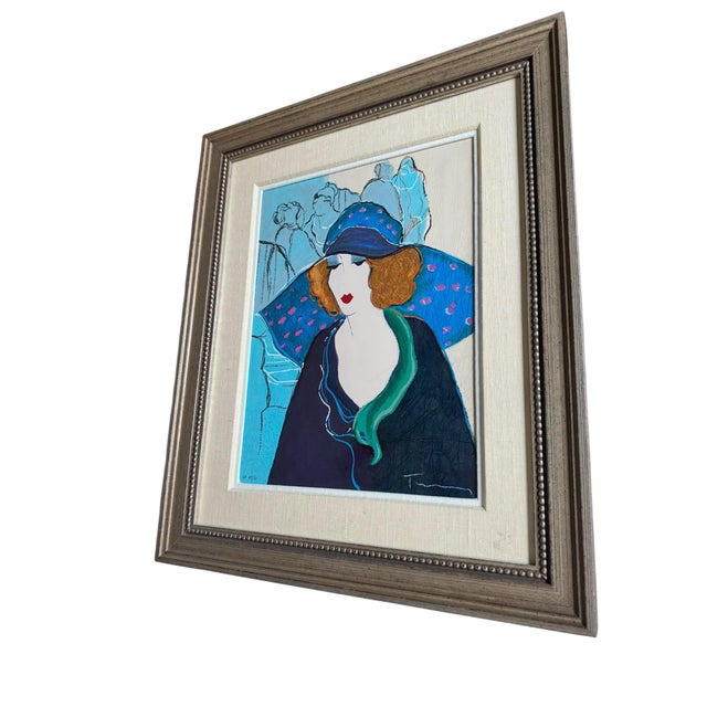 Original limited-edition serigraph by Israeli artist Itzchak Tarkay (1935–2012) titled “Chapeau Bleu.” This example is an...