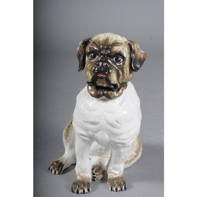 Life-size ceramic pug dog, England, 20th century This antique-inspired ceramic pug figurine in the Staffordshire style...