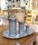 This antique French pewter measuring set comprises three graduated lidded measures accompanied by a large oval serving...