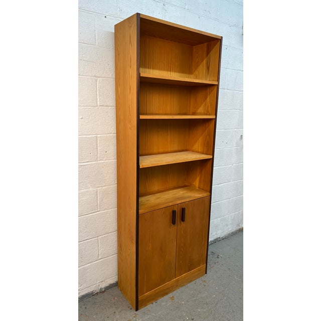 Add warmth, style, and functionality to your home with this classic Mid-Century Modern teak bookcase. Showcasing clean...