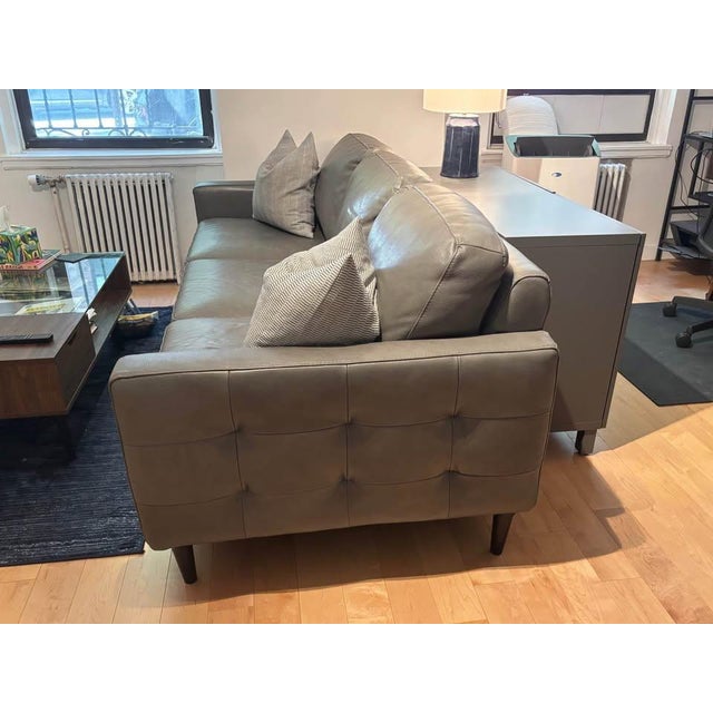 Like New gray Chateau D’Ax leather couch. Only owner. Pet-free home. Dimensions: Width: 84 inches, Depth: 38 inches,...