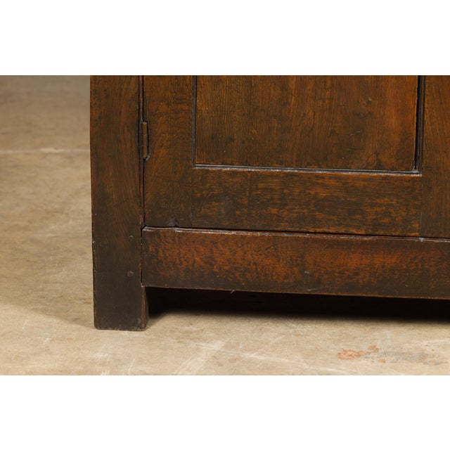 An English oak buffet from the 19th century with four drawers, three doors and brass Chippendale style hardware. Immersing...