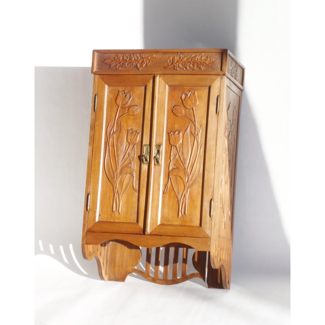 Antique wooden cabinet in Art Nouveau style with amazing carvings all over. The front doors as well as the sides, have...