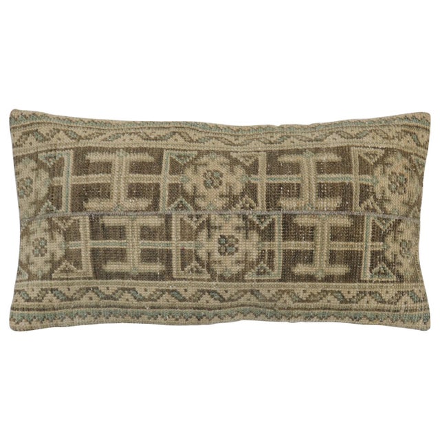 Pillow made from a Turkish Oushak rug. Tan brown and green accents. Measures: 16" x 31''.