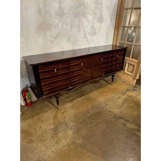 The French Mid Century Macassar Sideboard is a stylish and functional piece of furniture . Its classic mid-century design...