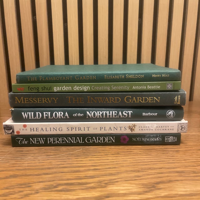 A beautifully composed, decorator-ready stack of garden and botanical books unified by a serene green palette and...
