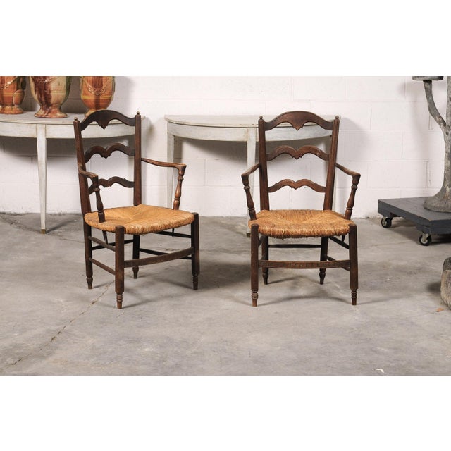 A charming pair of 19th century French rush seat armchairs, beautifully crafted with timeless provincial character....