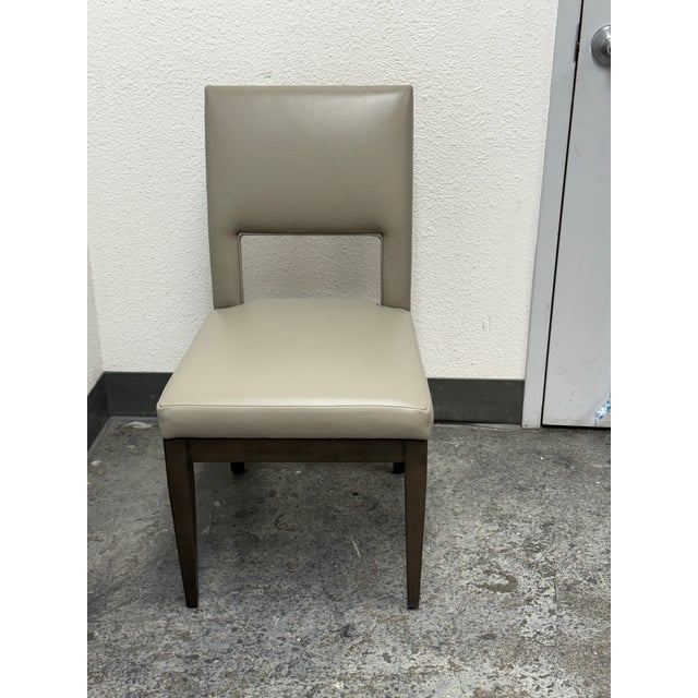 Design Plus Gallery presents the Joli Side Chair from Swaim. Upholstered in leather, this contemporary chair pairs a...