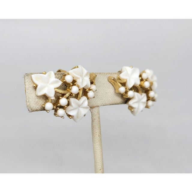 This is part of Chairish’s Costume Jewelry assortment. Mid to late 1950s goldtone white molded thermoset tutti frutti...
