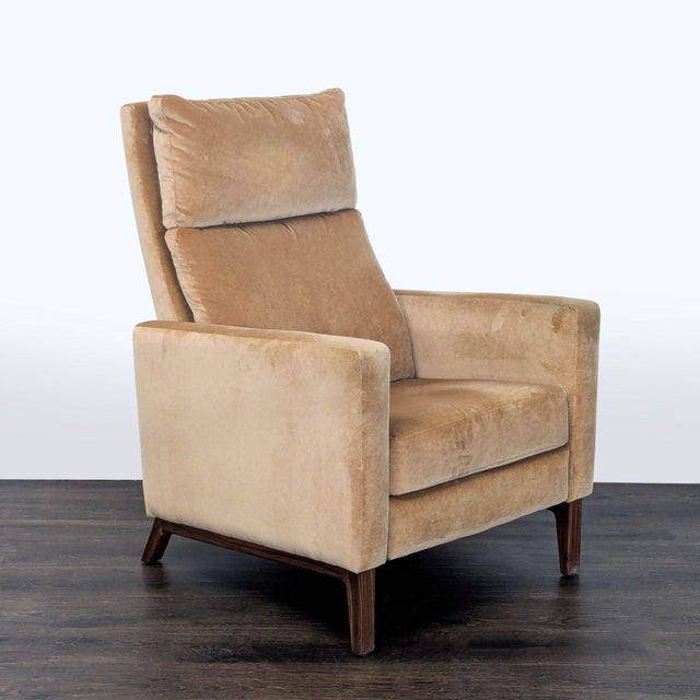 This Room and Board lounge chair features a soft tan upholstery and a sleek, modern design. It reclines for extra comfort...