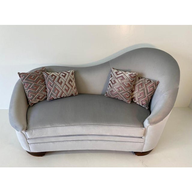 Elegant Italian sofa produced in the 1950s, distinguished by its graceful curved silhouette and sophisticated presence....
