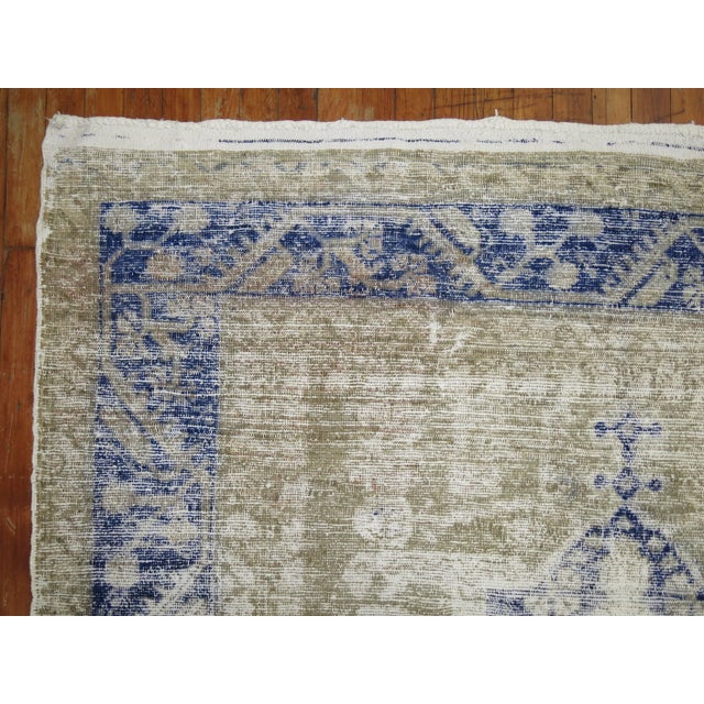 Beautiful worn 20th century gallery size Turkish rug. Faded blues and khaki tones. Measures: 5'6" x 10'11".