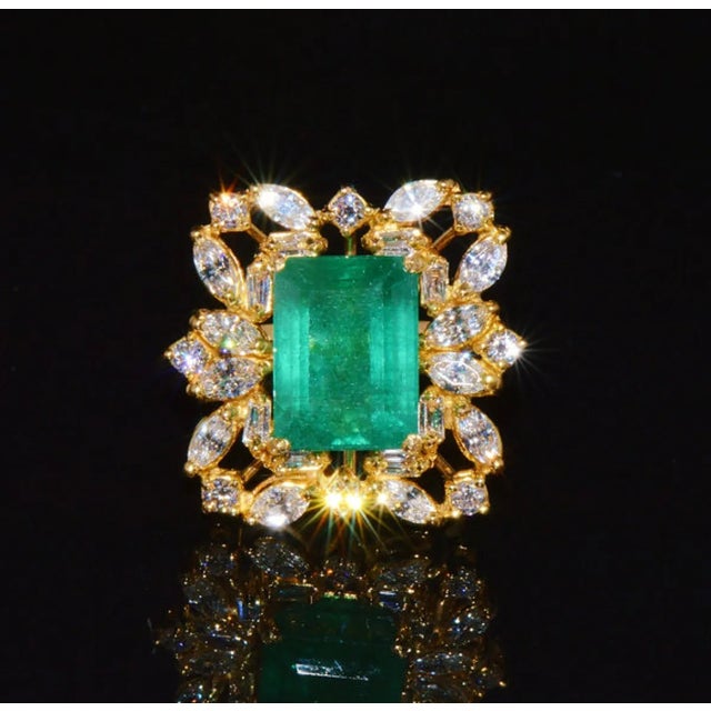 GIA certified 9CTS diamond & emerald 18K solid gold ring. This ring features a huge 7.34CT natural Zambian emerald. The...
