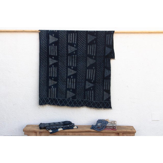 A masterwork of Malian textile heritage featuring deep indigo saturation and symbolic geometric motifs. Originating from...