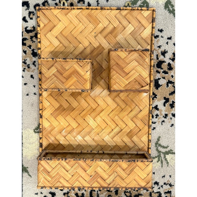 Large vintage woven rattan wall organizer. Three shelves edged in tortoise bamboo. One smaller, middle sized and largest...