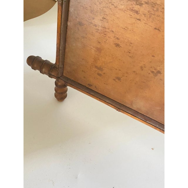 This is a Medium sizeFaux bamboo mirror, in a brown color. It has been made in France circa 1940.