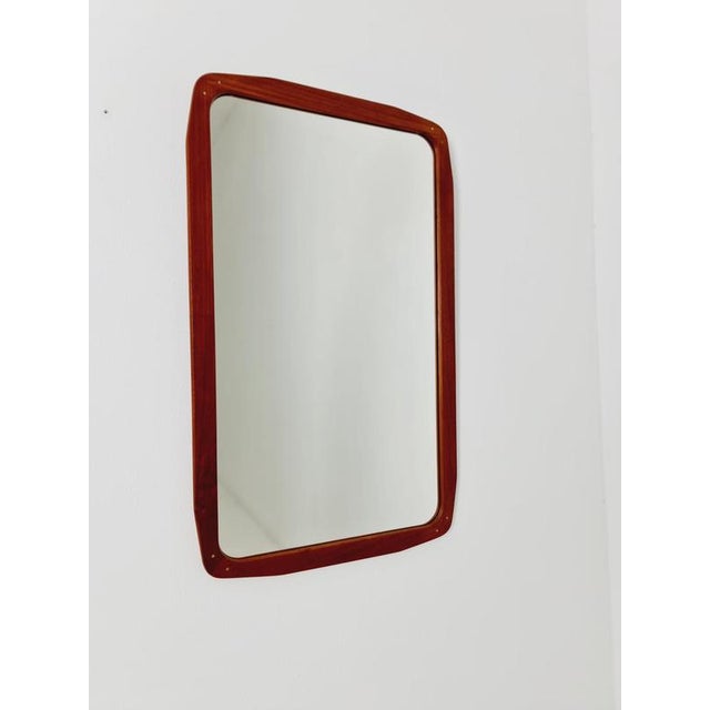 Big Danish teak and brass mid-century Modern wall-mounted mirror, 1960s Made in Denmark Height: 78 centimeters Width: 47...