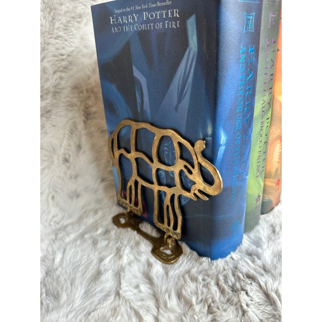 Vintage Reticular Brass Elephant bookend pair. Elephant feet detail and grass designed on bottom supports. These bookends...