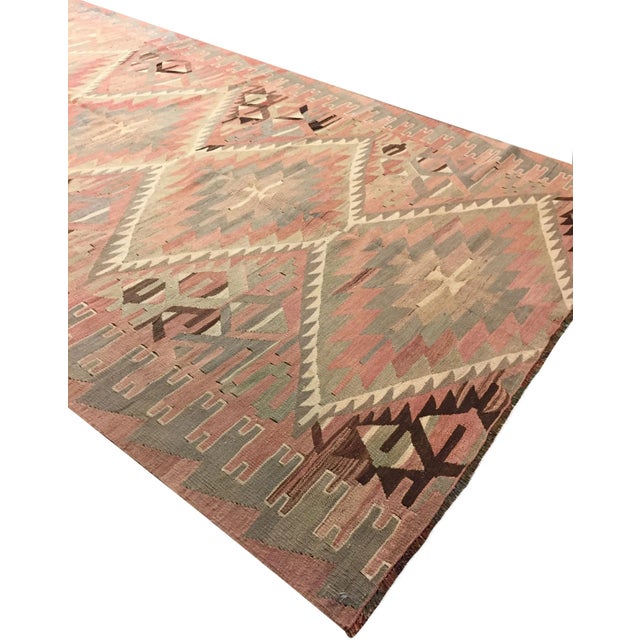 This vintage Turkish flat weave Kilim, handwoven in the 1940s, embodies both simplicity and boldness, allowing it to blend...