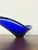 This elegant mid-century blue art glass dish is a refined example of sculptural glass design from the 1950s–1960s. The...