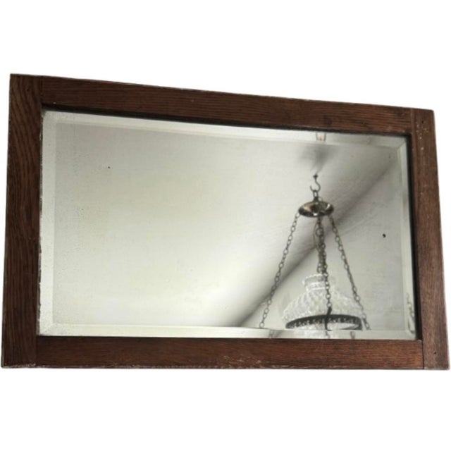 Historical 1870s quarter-sawn oak mirror featuring original cut-nail joinery, hand-silvered beveled glass, and a richly...