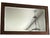Historical 1870s quarter-sawn oak mirror featuring original cut-nail joinery, hand-silvered beveled glass, and a richly...