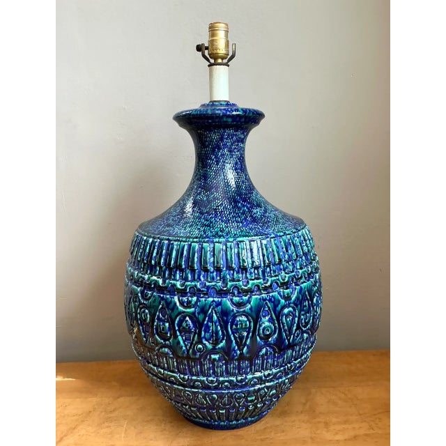A vintage mid-century modern ceramic lamp with a sculptural silhouette and a confident dose of color, this striking accent...