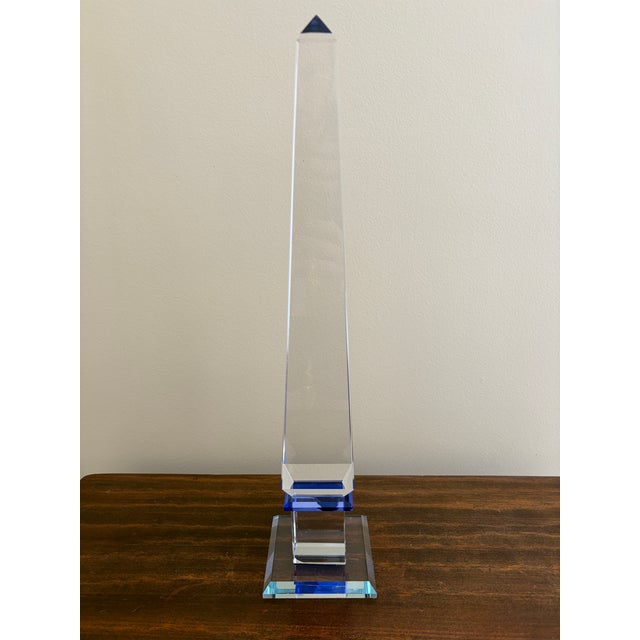 A stunning neoclassical or Grand Tour style solid crystal obelisk with cobalt blue accents USA, Late 20th Century...