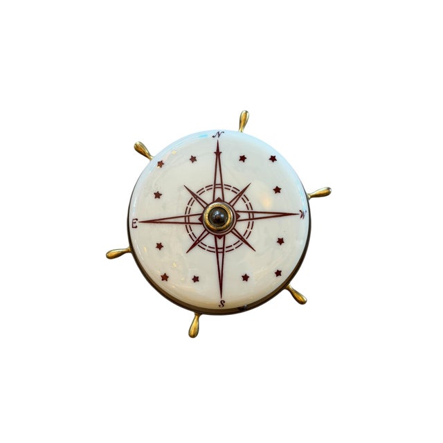 This vintage nautical ceiling light fixture is so charming. It features an off white glass shade with a maroon compass and...
