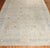 An early 20th Century Persian Meshed Oversize Rug. A paradise directional pattern in brown blue and ivory on a khaki field