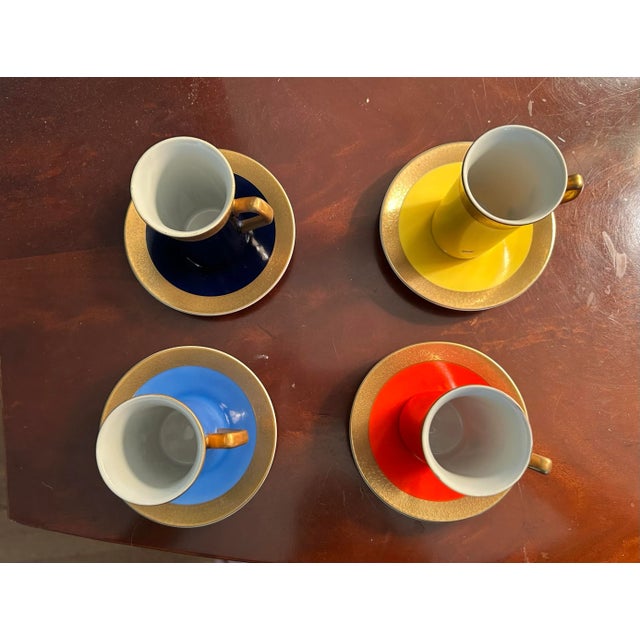 Porcelain Demitasse Set of 4 cups and saucers. The cups are 4" high and 2.5" across, saucers are 4" across.The colors are...