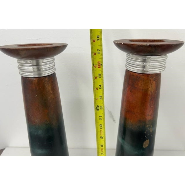 A striking and dramtic pair of sculptural pillar-form candleholders featuring rust-orange to deep teal ombré columns...