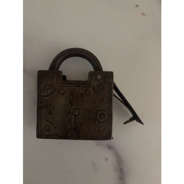 An evocative and a little spooky pair of antique locks. Made of metal. Smaller of two has original key. Each has engraved...