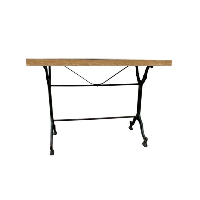 Wrought iron bistro table. with exposed antique engraving. Wooden top. Parisian style. Dimensions: Height 70 cm, Width 100...