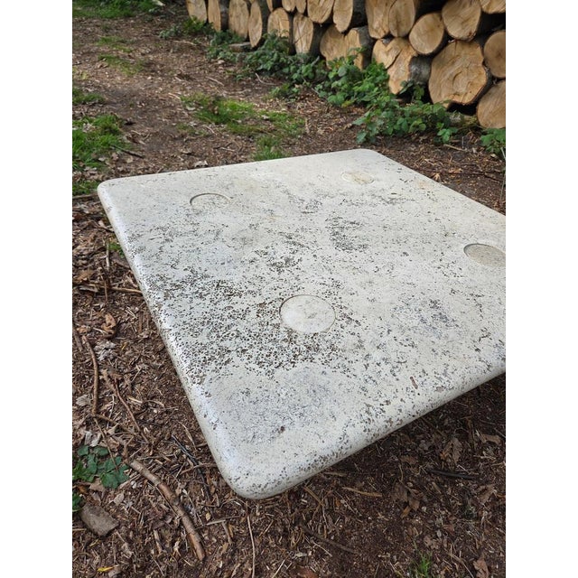 The square travertine coffee table attributed to Angelo Mangiarotti, produced in Italy during the 1970s, exemplifies the...
