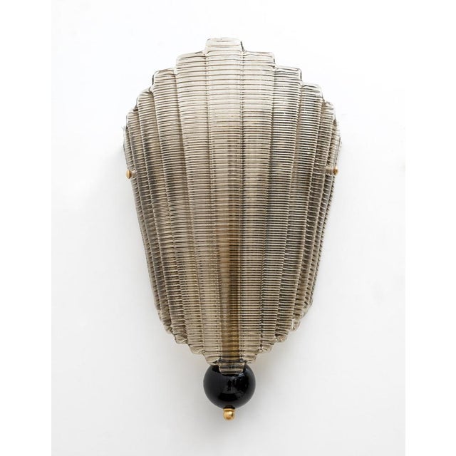 Pair of textured Murano glass wall lights. The glass is fluted and curved in design, creating a superb decorative impact,...