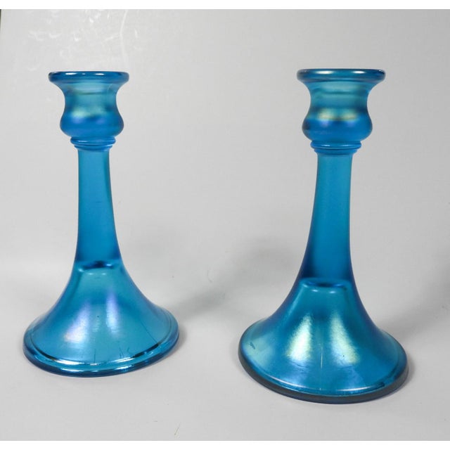 Vintage iridescent blue glass trumpet shape candle holders. Unmarked, holds a .75" candle, some surface scratches to base.