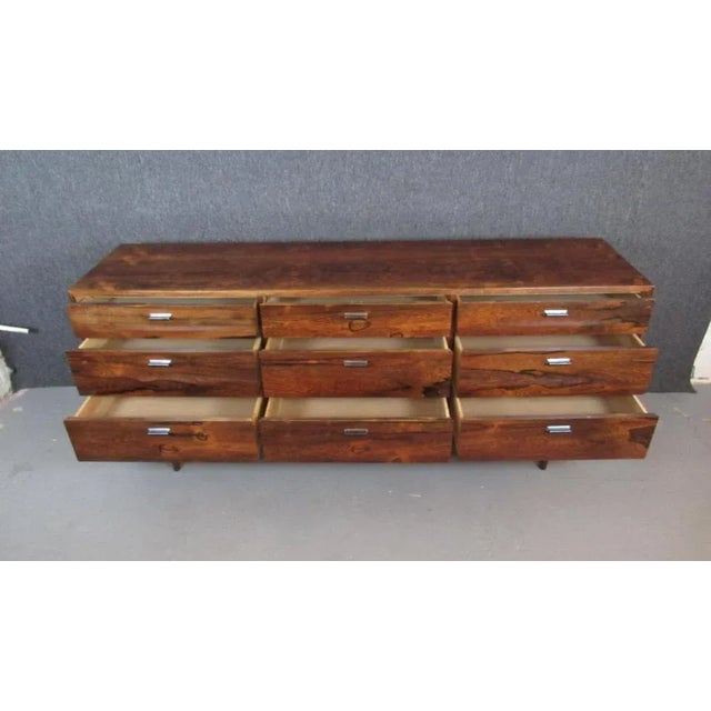 Exceptional mid-century rosewood dresser from American designer master Jack Cartwright for Founders Furniture. Nine ample...