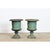 An elegant pair of late 19th century French cast iron planters in the silhouette of Medici urns", displaying a...