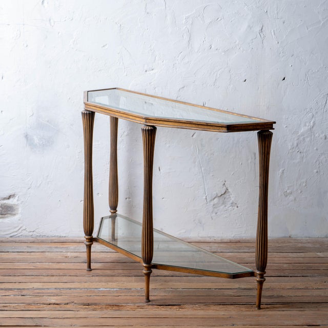 A French Art Deco gilt metal two tier glass console table, circa 1970s. Similar tables attributed to Émile-Jacques...