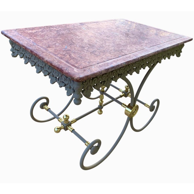 This is an antique cast iron pastry table, with the soft gray painted finish and gilding of the decorative finials and...