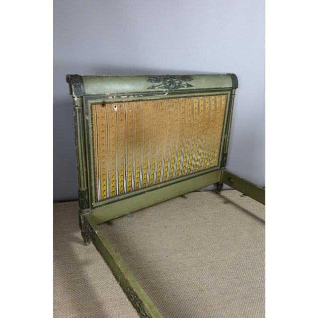 Directoire bed in painted wood from the 19th century. This bed is a middle bed, the bedside tables are rolled into crosses...