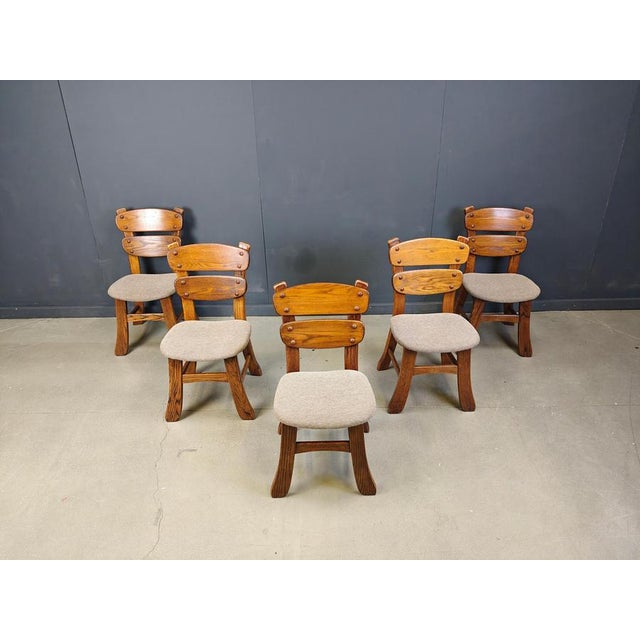 Vintage brutalist dining chairs with sturdy wooden frames and grey fabric upholstery. Cool, rustic chairs that will last...