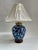 Classic Chinoiserie blue & white ginger jar shaped table lamp with original shade. No maker's mark. Uses standard bulb....