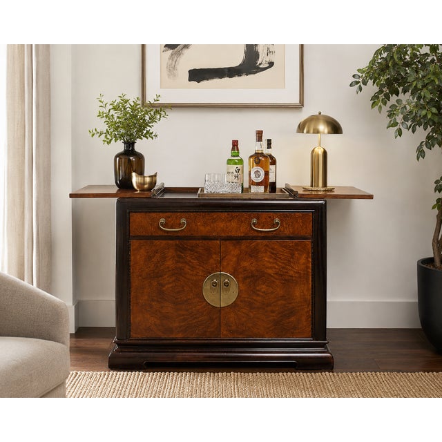 A handsome vintage server cabinet by Bernhardt featuring richly figured burlwood veneer contrasted by a deep espresso-...