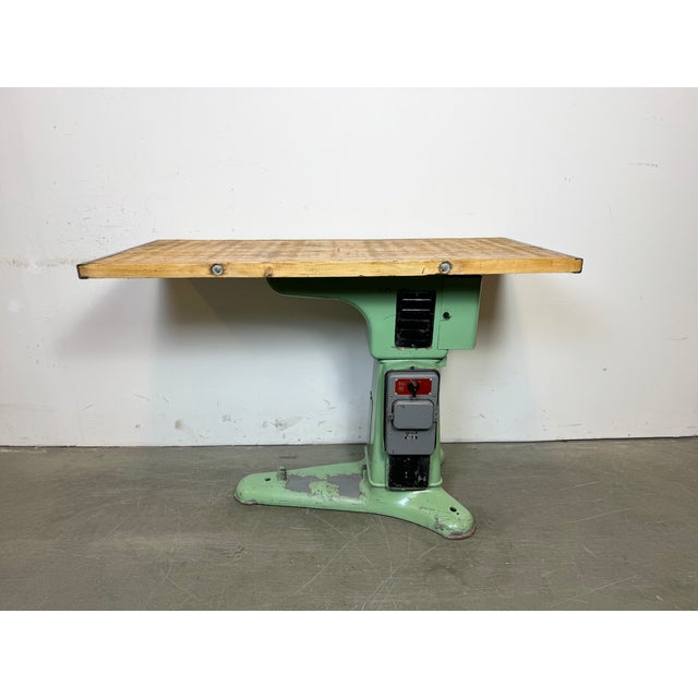 Green industrial table made in former Czechoslovakia during the 1960s. Made of cast iron and wood.The weight of the table...