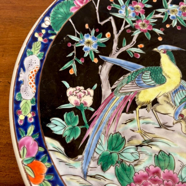 Striking porcelain charger plate depicting a lovely pheasant pair in a landscape. Deep black background is punctuated by...
