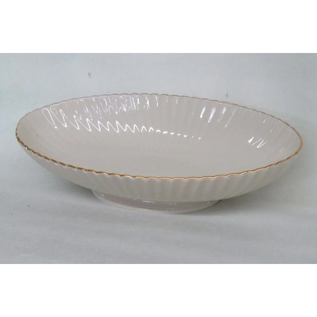This beautiful bowl is made of fine china. This piece is stamped as being made by Lenox in the United States, see...