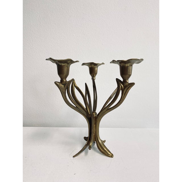 A fine, chiseled, three-flame candlestick in the style of French Art Deco.